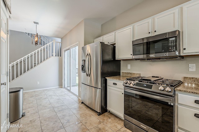 1482 S Banning St, Gilbert, AZ 85296 - kitchen with stainless steel appliances, white cabinetry, light stone counters, pendant lighting, and a chandelier