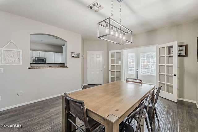 1482 S Banning St, Gilbert, AZ 85296 - dining area with french doors, dark wood finished floors, baseboards, arched walkways, and a chandelier