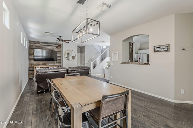 1482 S Banning St, Gilbert, AZ 85296 - dining area featuring ceiling fan, arched walkways, baseboards, and dark wood-type flooring