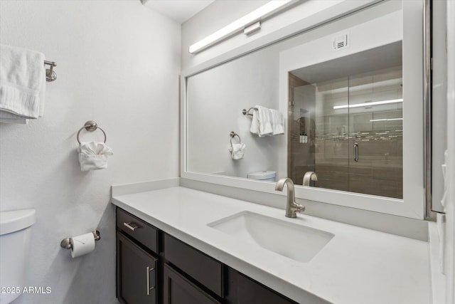 full bathroom with toilet, a stall shower, visible vents, and vanity