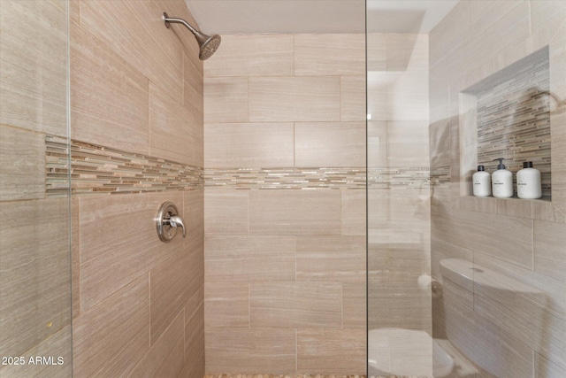 bathroom with tiled shower