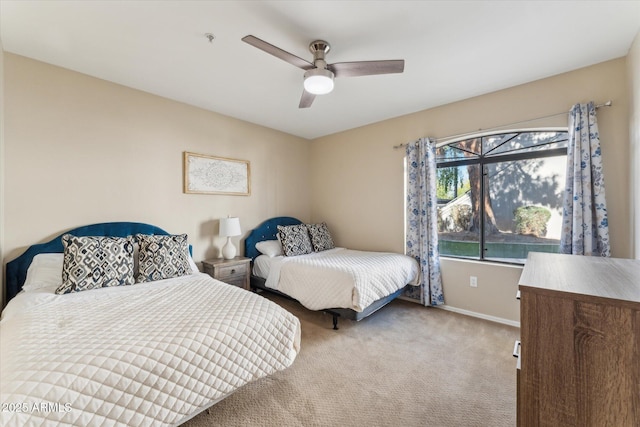 bedroom with carpet floors, a ceiling fan, and baseboards