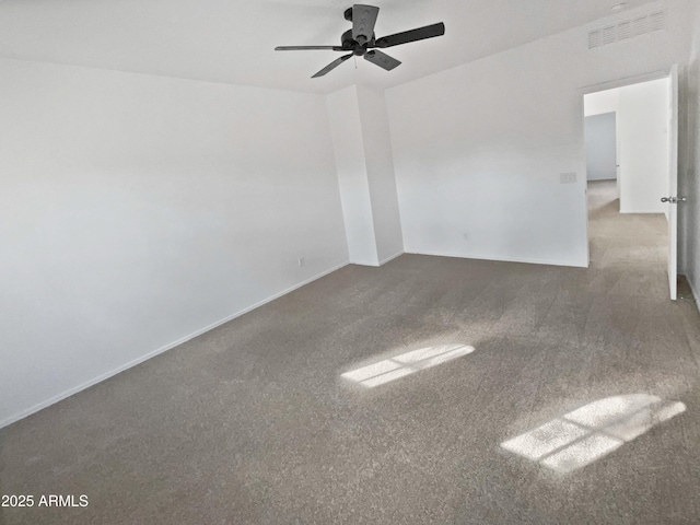 spare room featuring a ceiling fan, visible vents, and baseboards