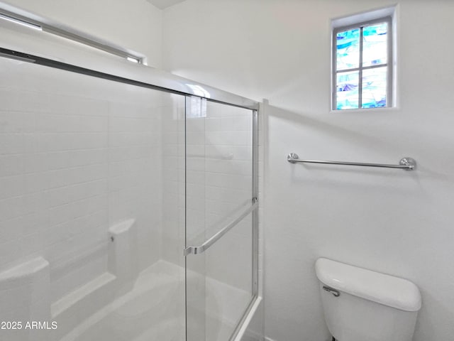 full bathroom featuring toilet and an enclosed shower