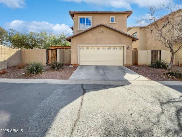 view of front facade featuring concrete driveway, a tile roof, a gate, fence, and stucco siding