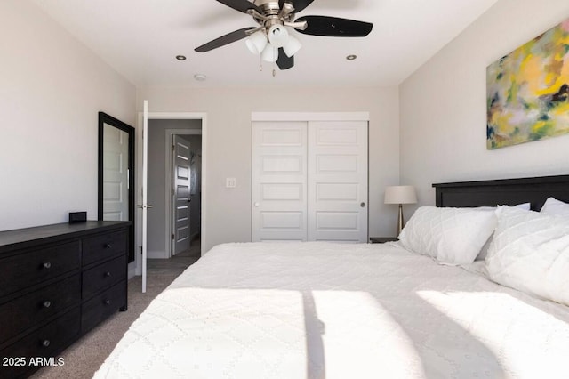 carpeted bedroom with a closet and ceiling fan