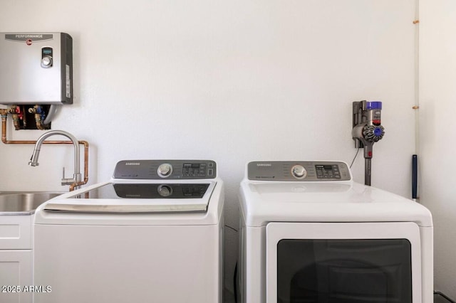 washroom with washer and clothes dryer and tankless water heater