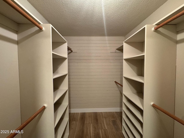 walk in closet featuring dark wood-style flooring