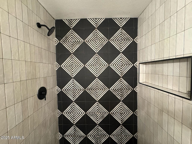 bathroom with a tile shower and a textured ceiling