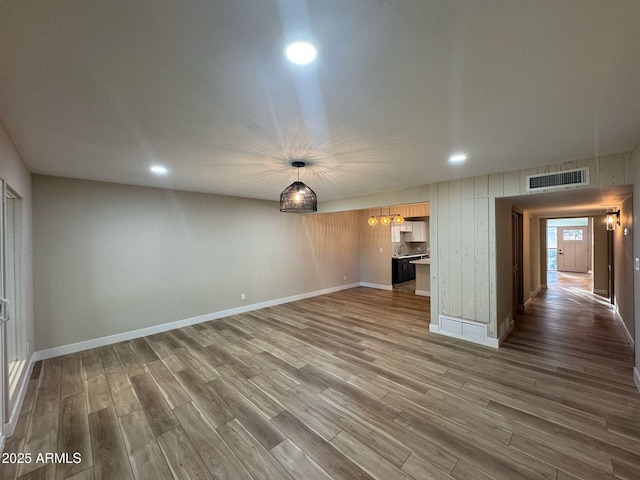 unfurnished room featuring recessed lighting, wood finished floors, visible vents, and baseboards