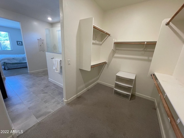 spacious closet with dark carpet