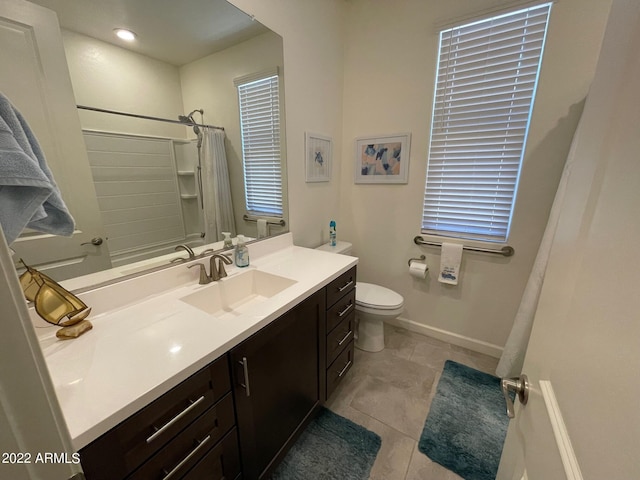 bathroom featuring tile patterned floors, vanity, and toilet