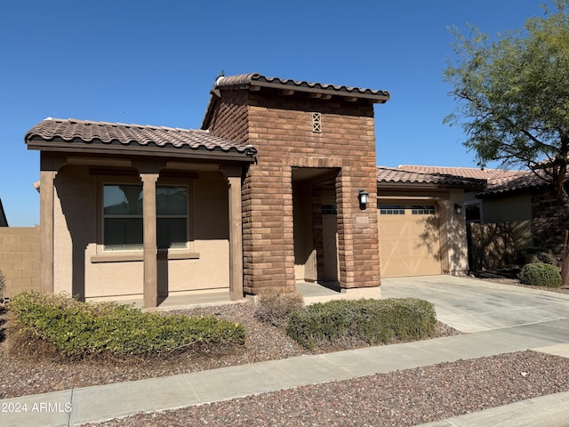 mediterranean / spanish-style home featuring a garage