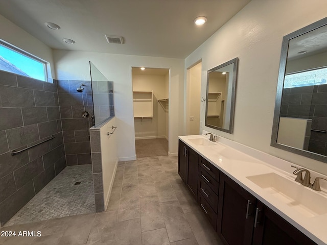 bathroom with vanity and tiled shower