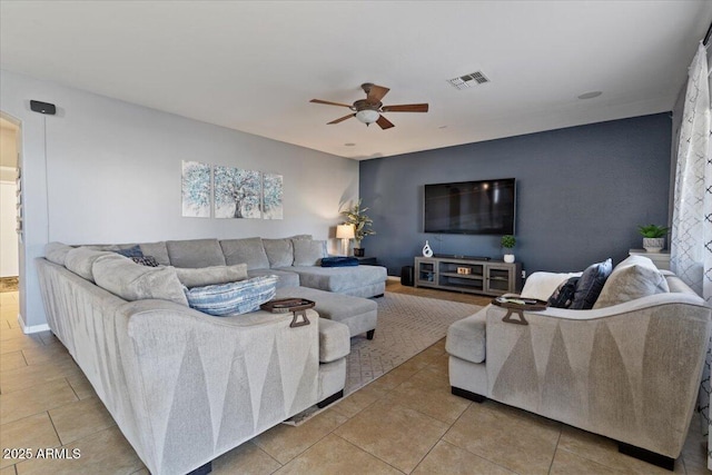 living room with ceiling fan and light tile patterned floors