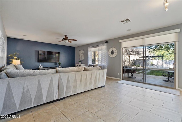 living room featuring ceiling fan and light tile patterned floors