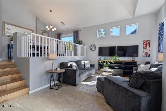 tiled living room featuring a notable chandelier and high vaulted ceiling