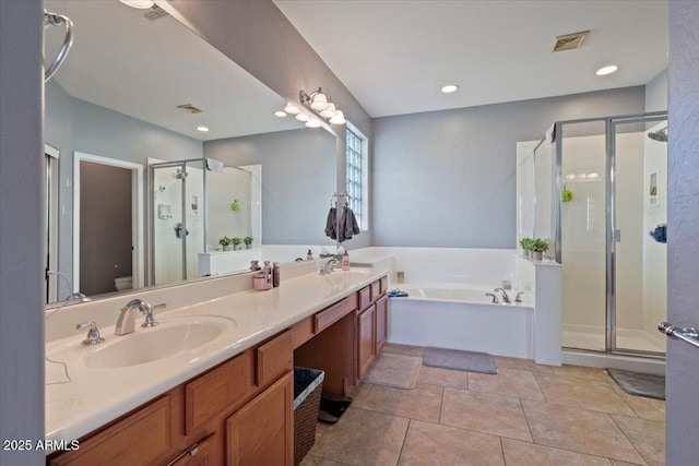 full bathroom with toilet, vanity, tile patterned floors, and independent shower and bath