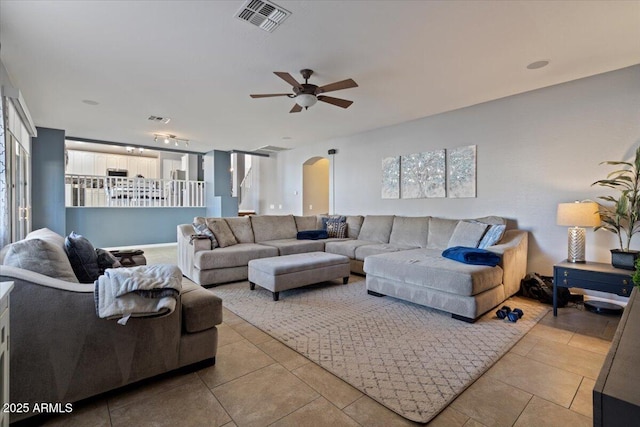 tiled living room featuring ceiling fan