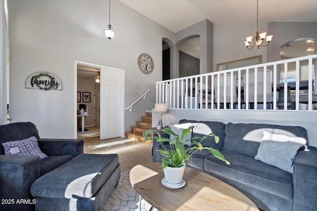 living room with high vaulted ceiling and a chandelier