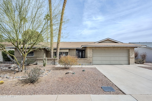 ranch-style home with a garage, driveway, and brick siding