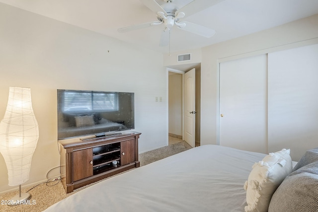 carpeted bedroom with baseboards, ceiling fan, visible vents, and a closet