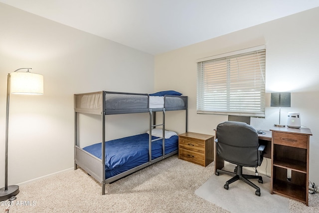 carpeted bedroom featuring baseboards