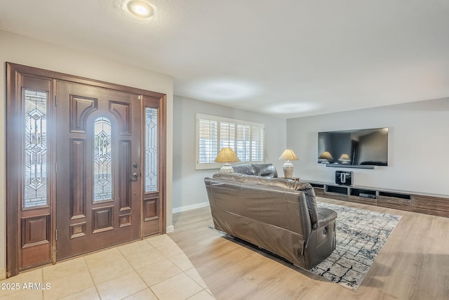 entryway with light wood-type flooring and baseboards