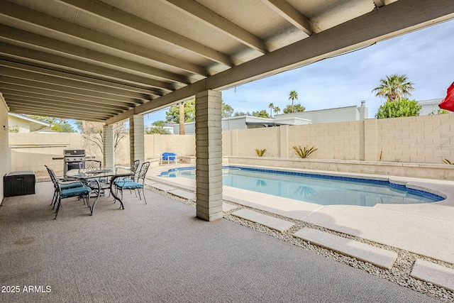 view of pool featuring a fenced backyard, area for grilling, a fenced in pool, outdoor dining space, and a patio area