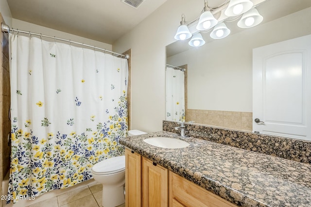 bathroom featuring a shower with curtain, visible vents, toilet, vanity, and tile patterned flooring