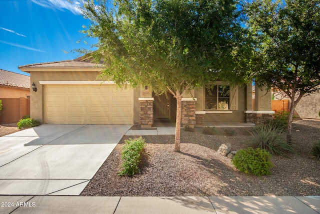 view of property hidden behind natural elements featuring a garage