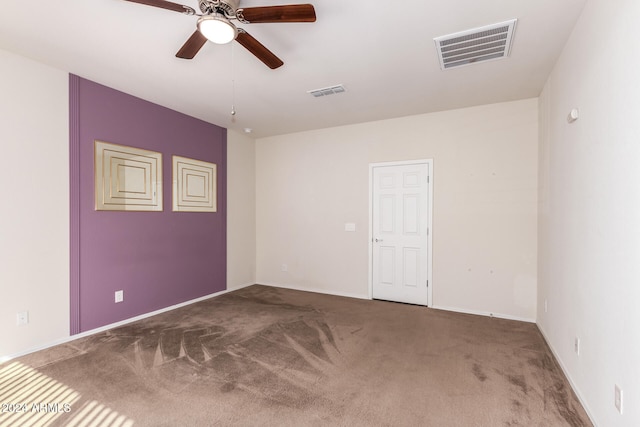 spare room featuring carpet floors and ceiling fan