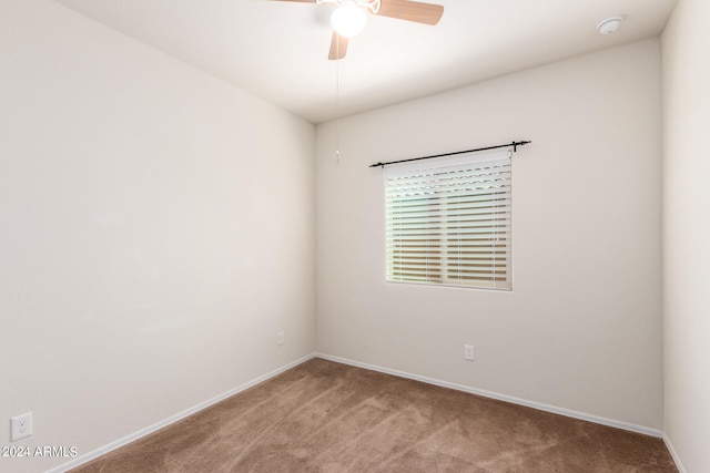 empty room featuring carpet floors and ceiling fan