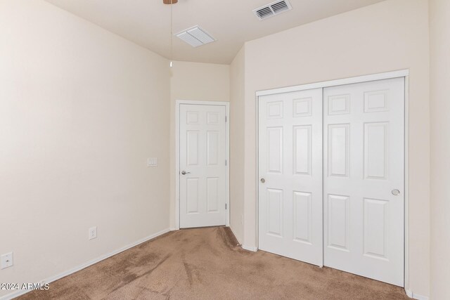 unfurnished bedroom with a closet and carpet flooring