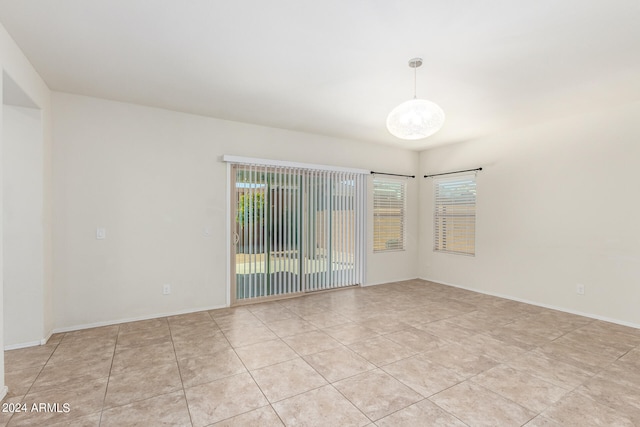 spare room with a healthy amount of sunlight and light tile patterned floors