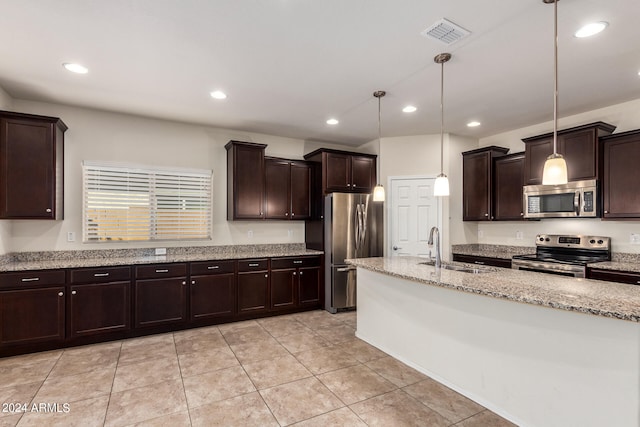 kitchen with sink, appliances with stainless steel finishes, hanging light fixtures, and light tile patterned floors