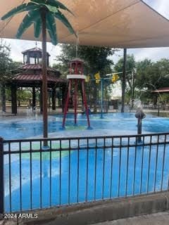 view of swimming pool with a gazebo and a playground