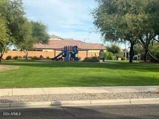 surrounding community with a playground and a yard