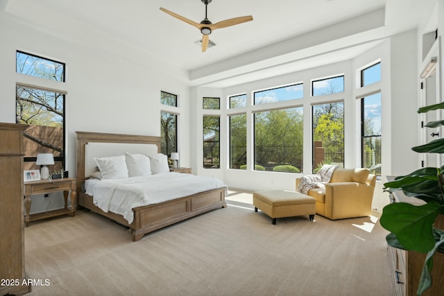 bedroom with carpet floors, multiple windows, ceiling fan, and visible vents