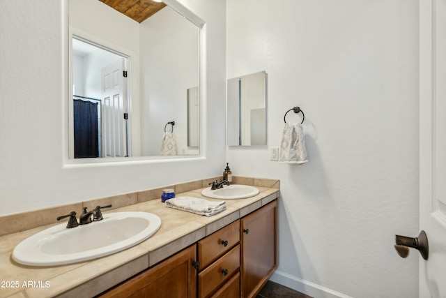 bathroom featuring double vanity, baseboards, and a sink