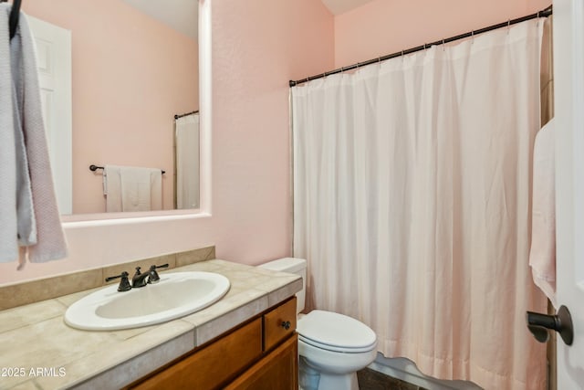 bathroom featuring a shower with curtain, vanity, and toilet