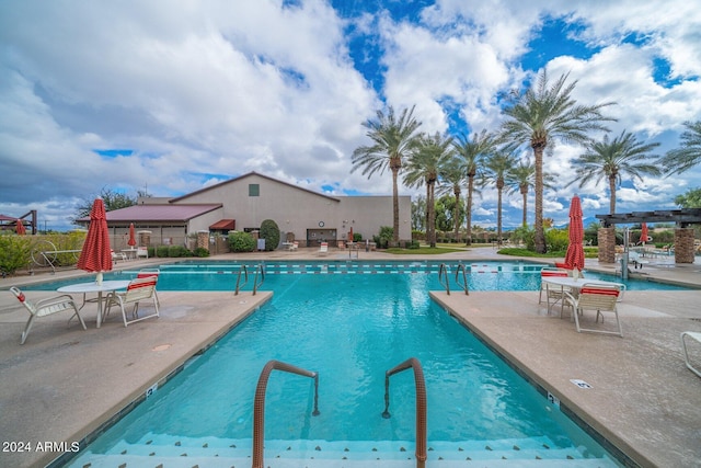 pool featuring a patio and fence