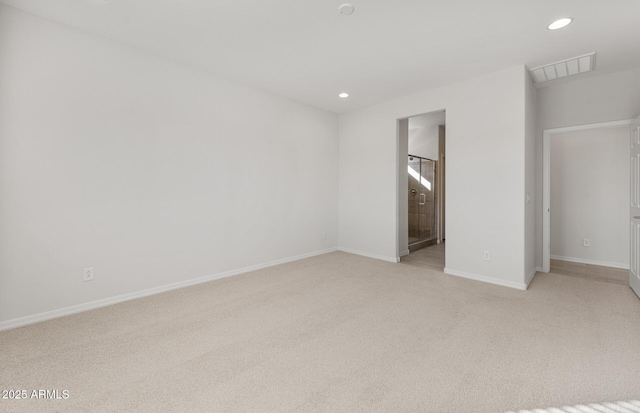 unfurnished bedroom featuring connected bathroom and light colored carpet