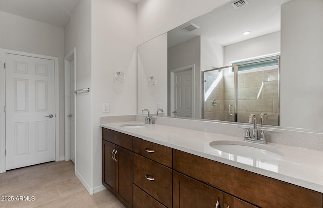 bathroom featuring vanity and a shower with shower door