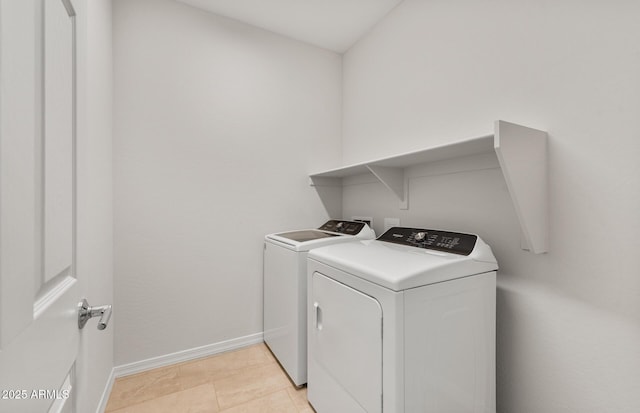 laundry room featuring light tile patterned flooring and washing machine and dryer