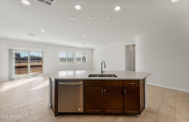 kitchen with dark brown cabinetry, sink, dishwasher, and a center island with sink