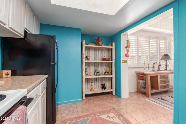 kitchen with white cabinets and light tile patterned flooring