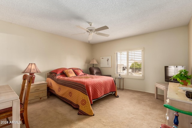 carpeted bedroom featuring a textured ceiling and ceiling fan