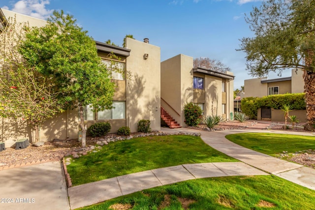 adobe home with a front lawn