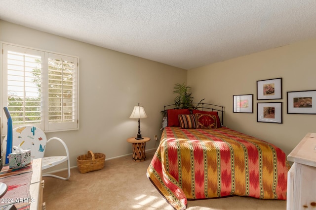 carpeted bedroom with a textured ceiling